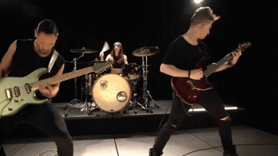 A Man Playing A Guitar In Front Of A Drum Set With A Sticker That Says ' Sr ' On It GIF