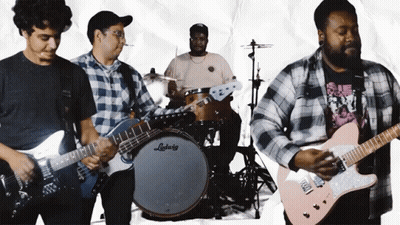 A Man Playing A Guitar In Front Of A Ludwig Drum Set GIF