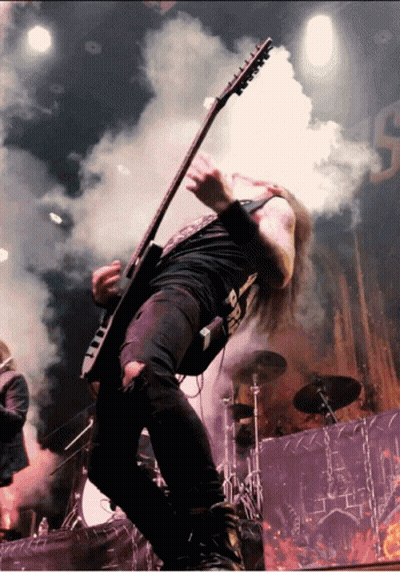 A Man Playing A Guitar With A Shirt That Says ' Death ' GIF