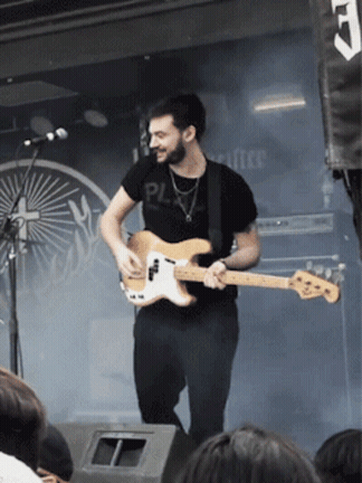 A Man Playing A Guitar With A Shirt That Says Pl GIF