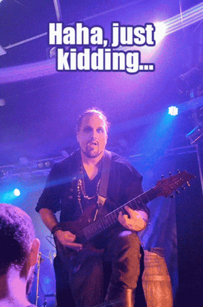 A Man Playing A Guitar With The Caption " Haha Just Kidding " Above Him GIF