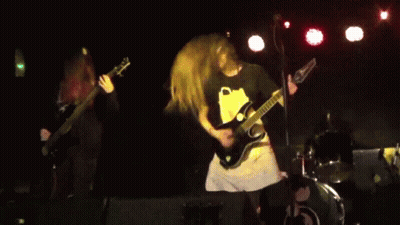 A Man Playing A Guitar With The Letter C On The Front GIF