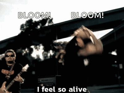 A Man Playing A Guitar With The Words Bloom I Feel So Alive GIF