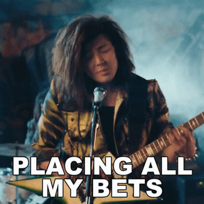 A Man Playing A Guitar With The Words Placing All My Bets Written Below Him GIF