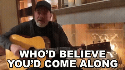 A Man Playing A Guitar With The Words " Who 'D Believe You 'D Come Along " Below Him GIF