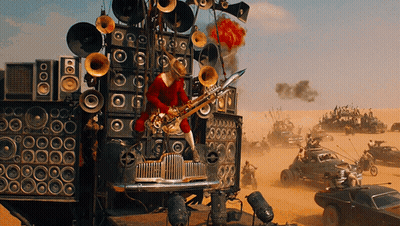 A Man Playing A Saxophone On Top Of A Car With A Lot Of Speakers On It GIF