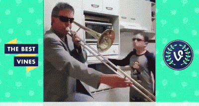 A Man Playing A Trombone In A Kitchen With The Words " The Best Vines " On The Bottom GIF