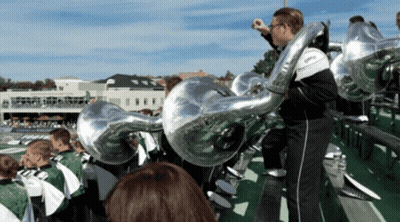 A Man Playing A Trumpet In A Marching Band With The Word Ohio On It GIF