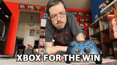 A Man Playing A Video Game With The Words Xbox For The Win Above Him GIF