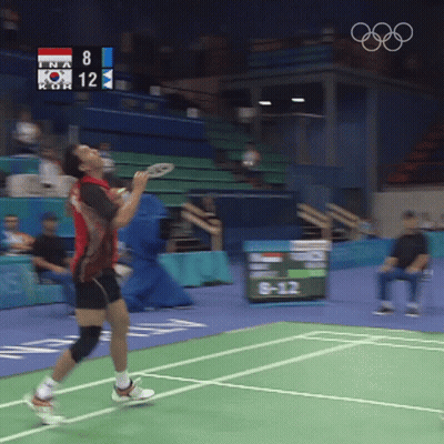 A Man Playing Badminton With A Scoreboard That Says 8 And 12 GIF
