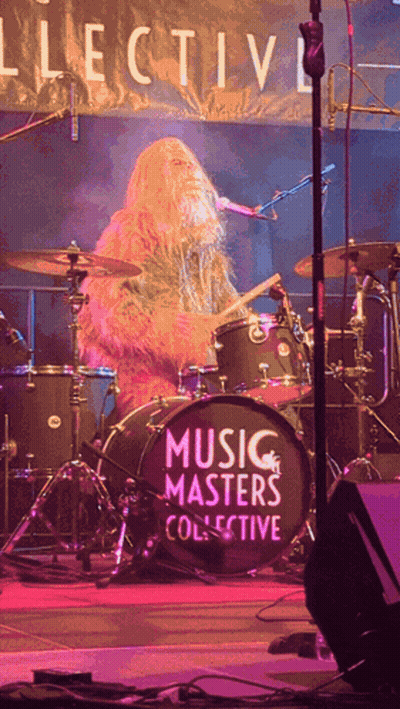A Man Playing Drums In Front Of A Drum Set That Says Music Masters Collective GIF