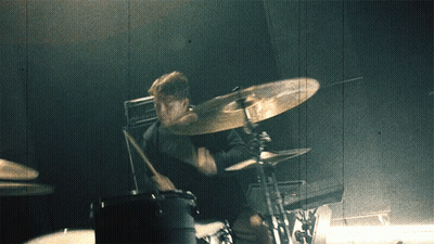 A Man Playing Drums With A Cymbal That Says Zildjian On It GIF