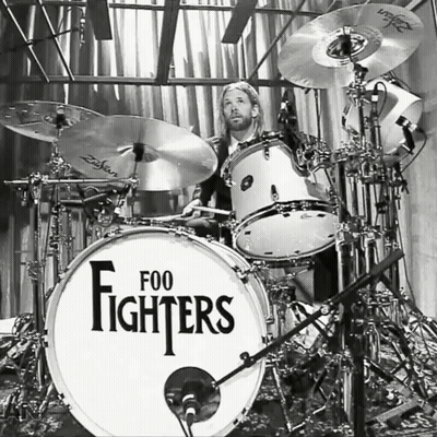 A Man Playing Drums With A Drum Set That Says Foo Fighters On It GIF