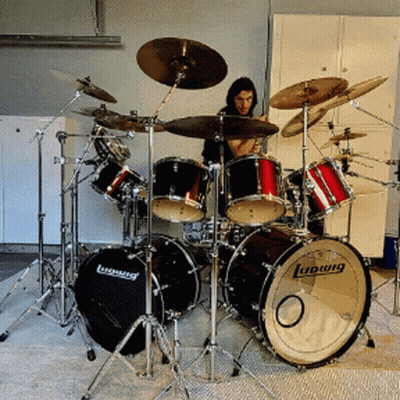 A Man Playing Drums With A Ludwig Drum In The Foreground GIF