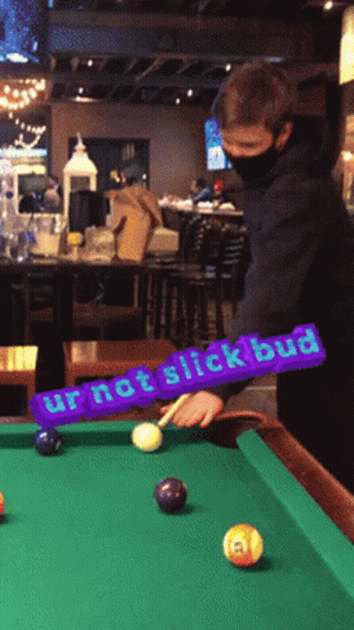 A Man Playing Pool With A Purple Sign That Says Ur Not Slick Bud GIF