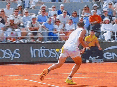 A Man Playing Tennis On A Court With A Sign That Says Infosys GIF