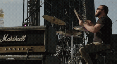 A Man Plays Drums In Front Of A Marshall Amp GIF