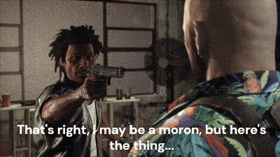 A Man Pointing A Gun At Another Man With The Words That 'S Right May Be A Moron GIF