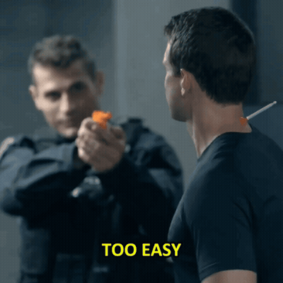 A Man Pointing A Gun At Another Man With The Words Too Easy Visible GIF