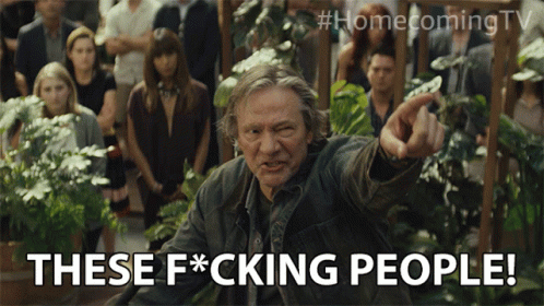 A Man Pointing At A Crowd With The Words These F * Cking People Below Him GIF