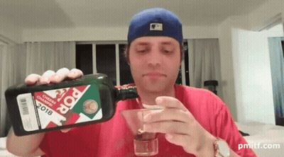 A Man Pouring A Martini From A Bottle That Says Pop On It GIF