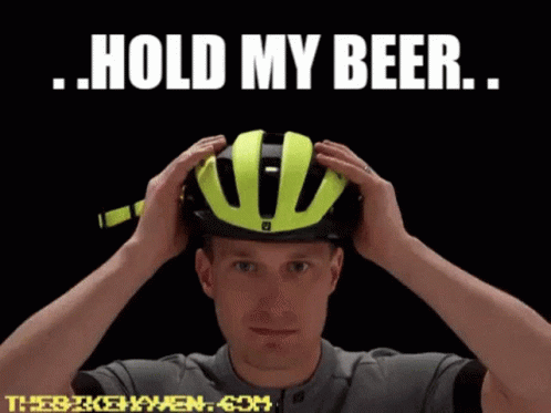A Man Putting On A Helmet With The Words Hold My Beer GIF