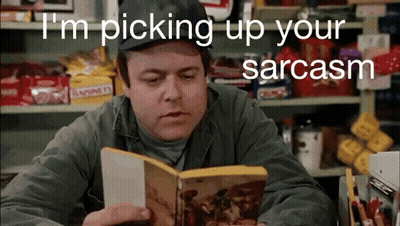 A Man Reading A Book With The Words " I 'M Picking Up Your Sarcasm " Behind Him GIF