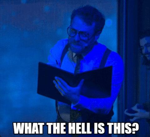 A Man Reading A Book With The Words " What The Hell Is This " Written Below Him GIF