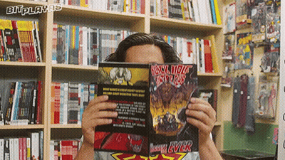 A Man Reads A Comic Book Called Black Hole GIF