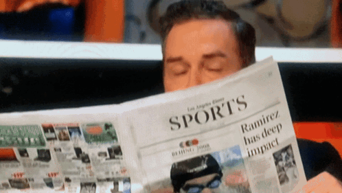 A Man Reads The Sports Section Of The Los Angeles Times Newspaper GIF