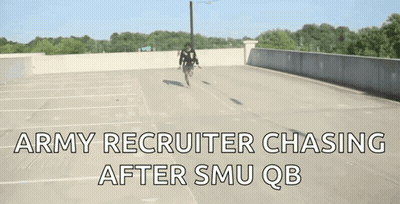 A Man Riding A Bike In A Parking Lot With The Words " Army Recruiter Chasing After Smu Qb " On The Bottom GIF