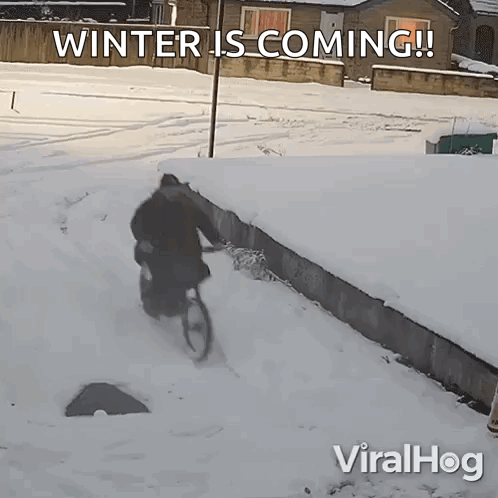 A Man Riding A Bike In The Snow With The Words Winter Is Coming On The Bottom GIF