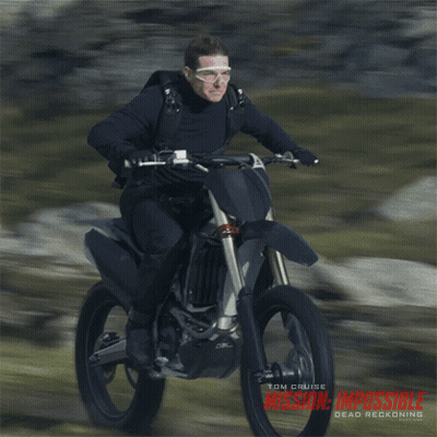 A Man Riding A Dirt Bike With The Word Mission Impossible On The Bottom GIF