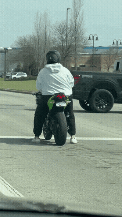 A Man Riding A Green Motorcycle With A License Plate That Says ' Jcl ' On It GIF