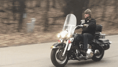 A Man Riding A Harley Davidson Motorcycle With A License Plate That Says Rb GIF