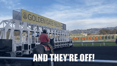 A Man Riding A Horse In Front Of A Sign For Golden Gate Fields GIF