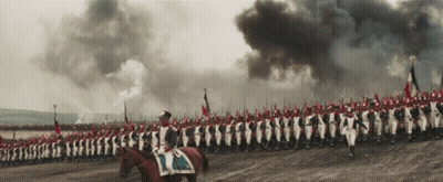 A Man Riding A Horse Leads A Large Military Parade GIF