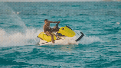 A Man Riding A Jet Ski In The Ocean GIF