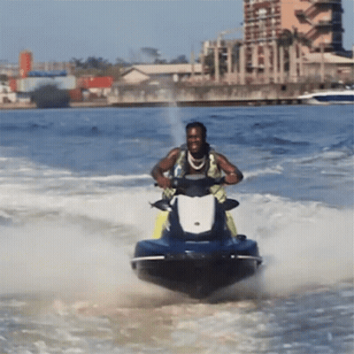 A Man Riding A Jet Ski In The Ocean GIF