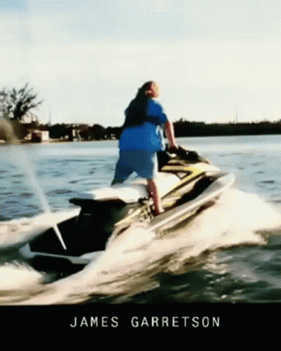 A Man Riding A Jet Ski In The Water With The Name James Garratson GIF