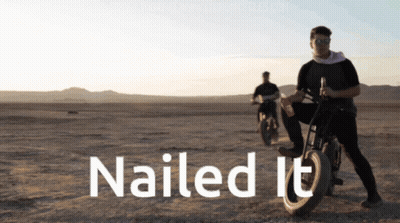 A Man Riding A Motorcycle In The Desert With The Words Nailed It Above Him GIF