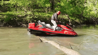 A Man Riding A Red Yamaha Jet Ski In The Water GIF