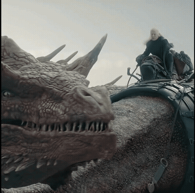 A Man Riding On The Back Of A Dragon With A Sword GIF