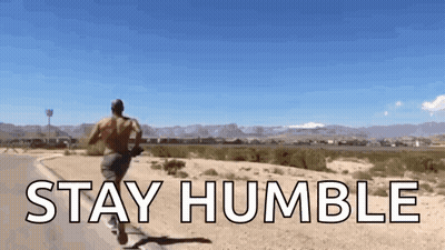 A Man Running Down A Road With The Words " Stay Humble " Written On It GIF