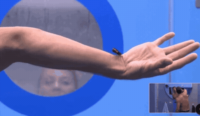 A Man 'S Arm Is Shown In Front Of A Blue Circle GIF