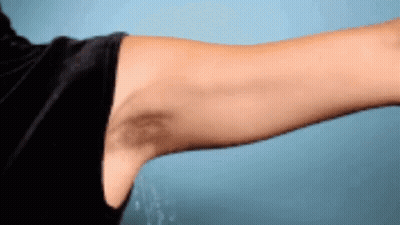 A Man 'S Arm With A Black Spot On It GIF