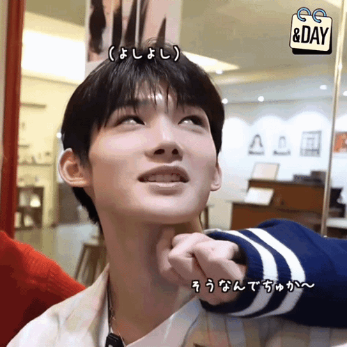 A Man 'S Face Is Being Touched By Someone With A Sign That Says Day GIF