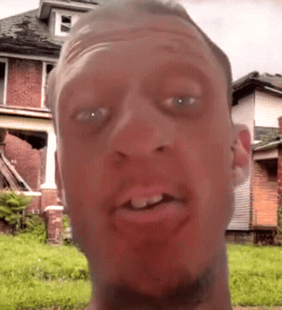 A Man 'S Face Is Shown With A House In The Background GIF