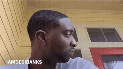 A Man 'S Face Is Shown With The Words Iamdesibanks Above It GIF