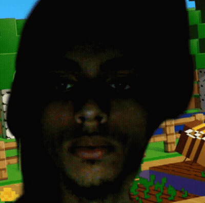 A Man 'S Face Is Visible In The Dark In Front Of A Minecraft Scene GIF